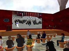 The crowd at Malburns Metahub watches the crowd at Metanomics 
 main watching  Enterprise 2.0 RL - Chimera Cosmos